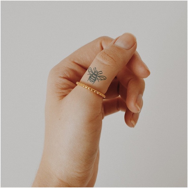 Tiny Honey Bee Finger Tattoo